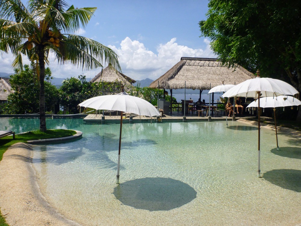 One of the pools with umbrellas at the Blue Lagoon resort in Bali Indonesia
